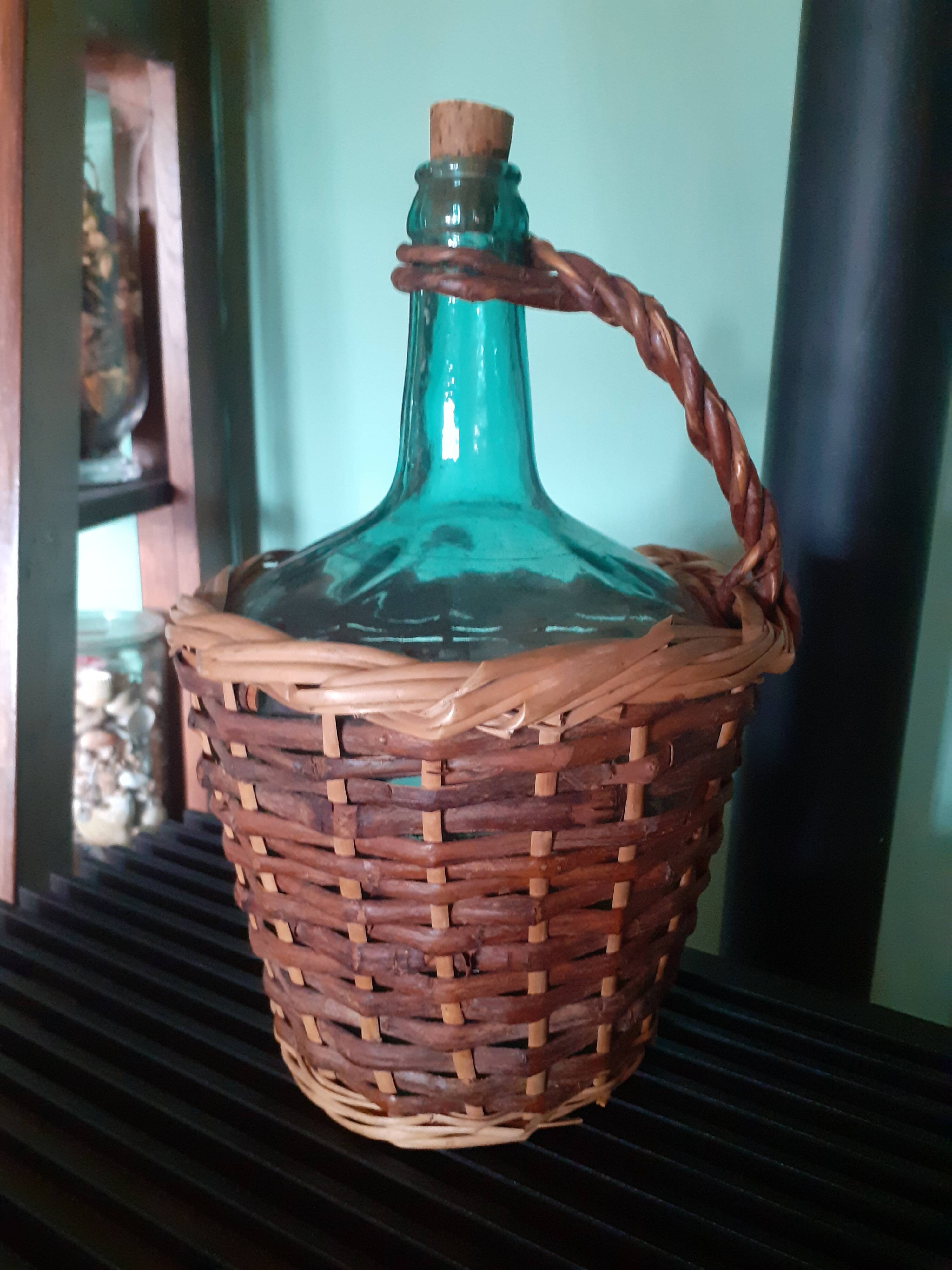 Glass bottle in its wicker dress