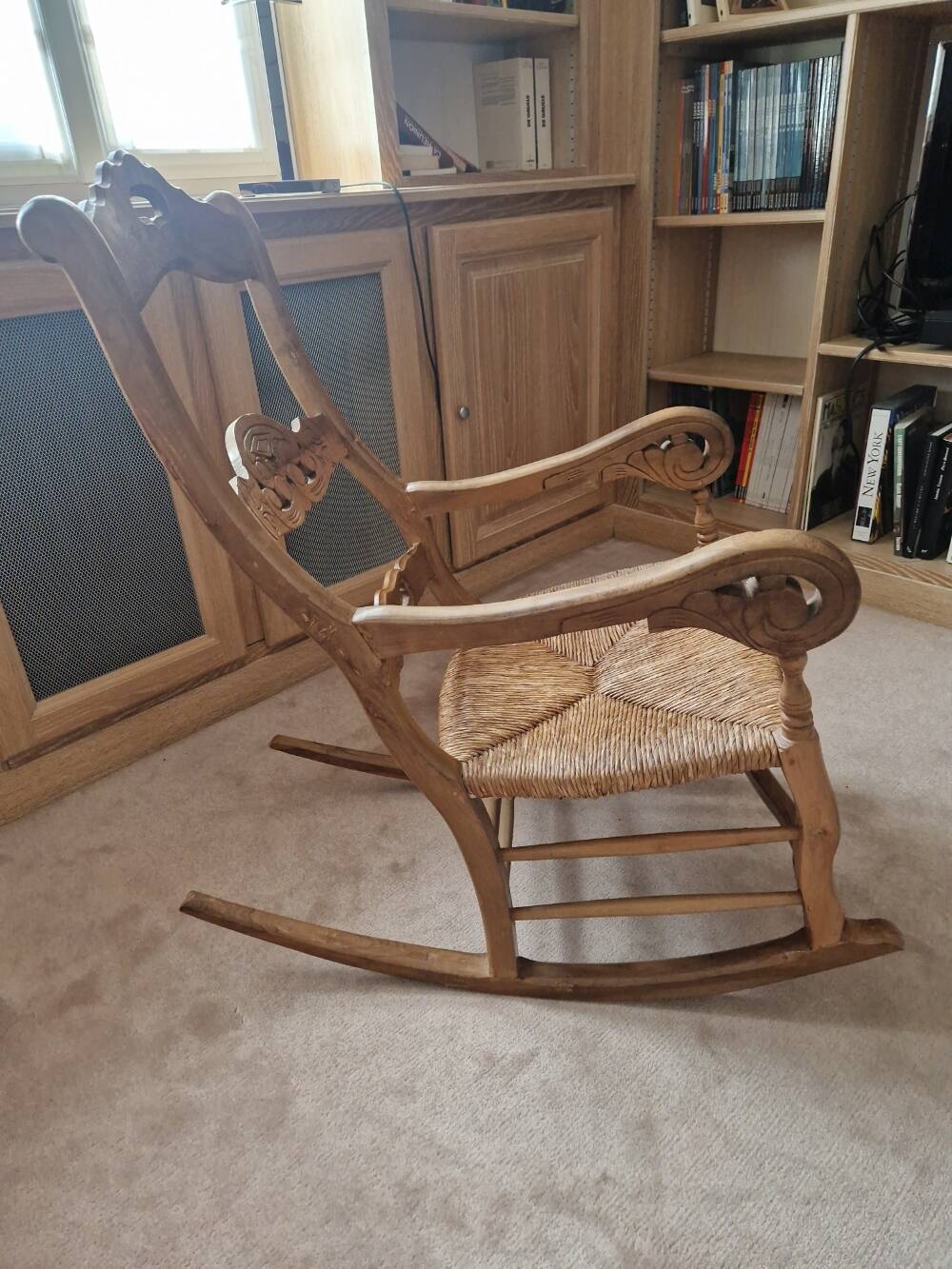 Oak rocking chair with a straw seat.