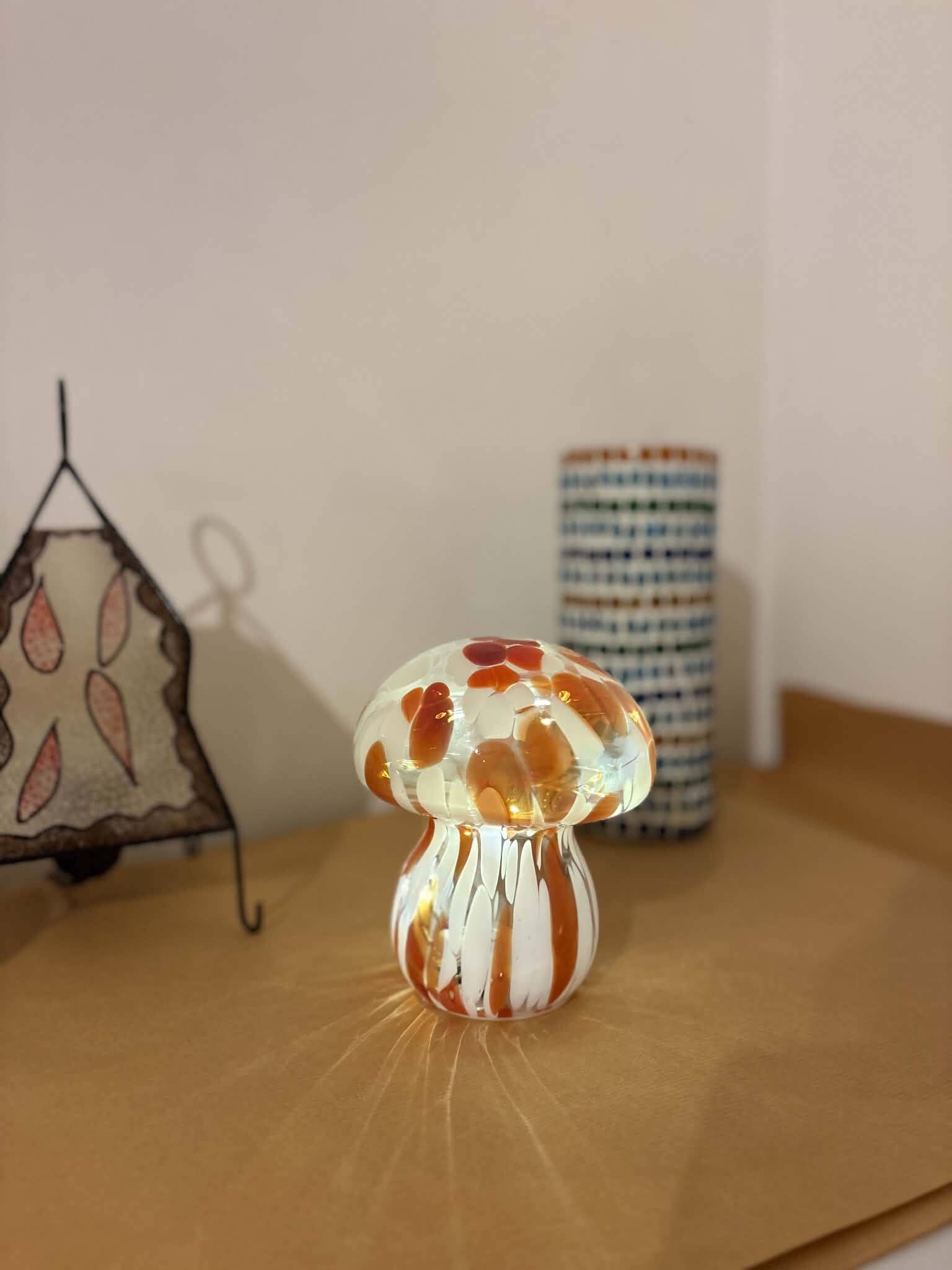 Mosaic glass mushroom lamp in orange, white, and clear.
