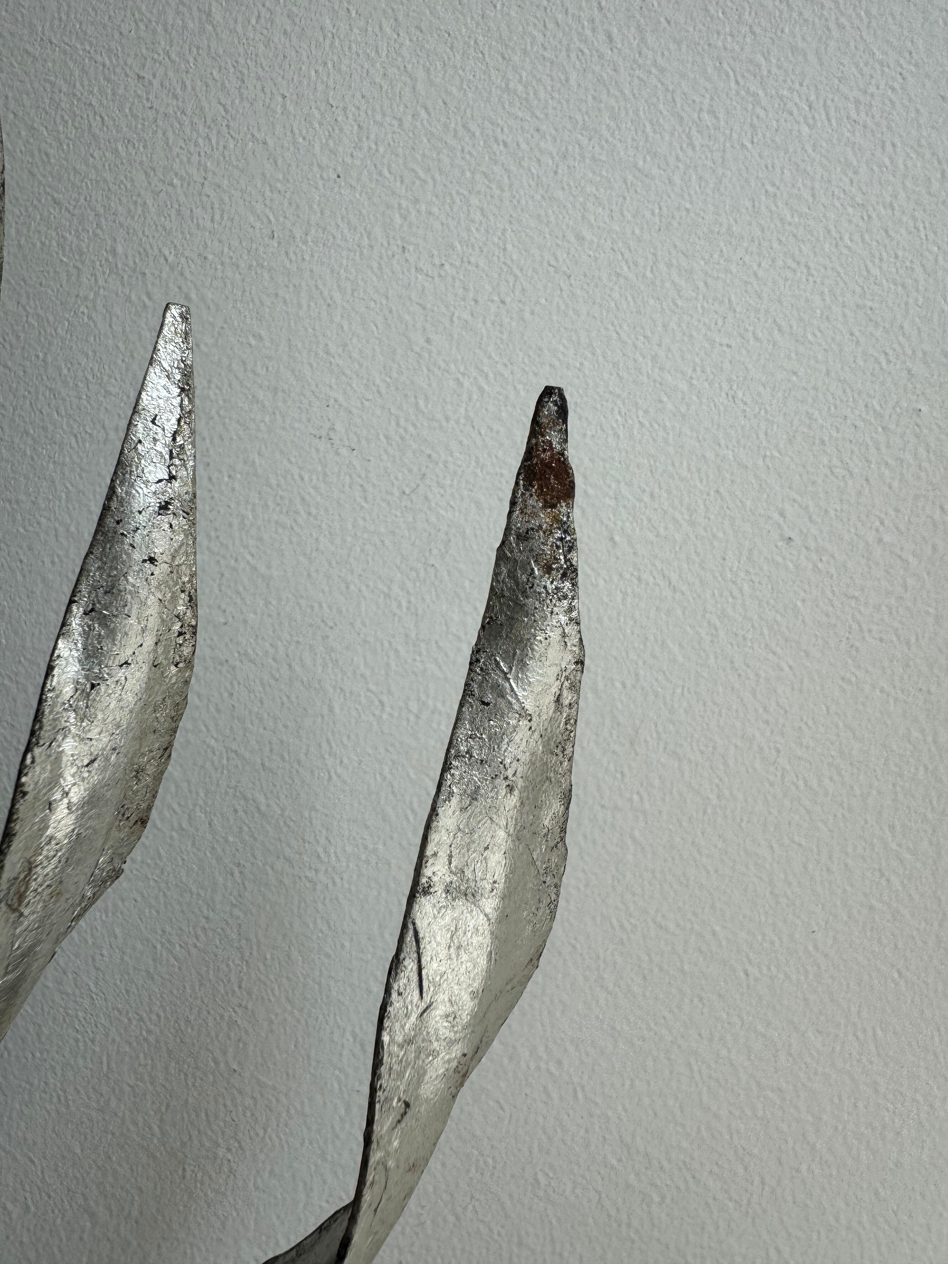 Silver wrought iron sunburst wall light from the 1960s.