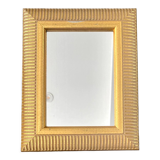 Mirror with striated and gilded decor