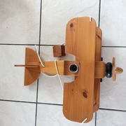 Light wood hanging in the shape of an airplane. Electric.Year 70.