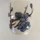 Set of three hand-painted porcelain cups with floral patterns.