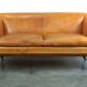 Unique old set of 2 club armchairs and a couch in cognac-colored leather with wheels