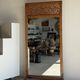 Very large freestanding teak mirror with an openwork carved pediment, Indonesia.
