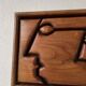 Bas relief cadre bois motifs visages