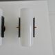 Set of four wall lights in white plexiglass and perforated black metal.