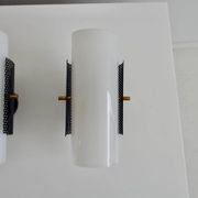 Set of four wall lights in white plexiglass and perforated black metal.