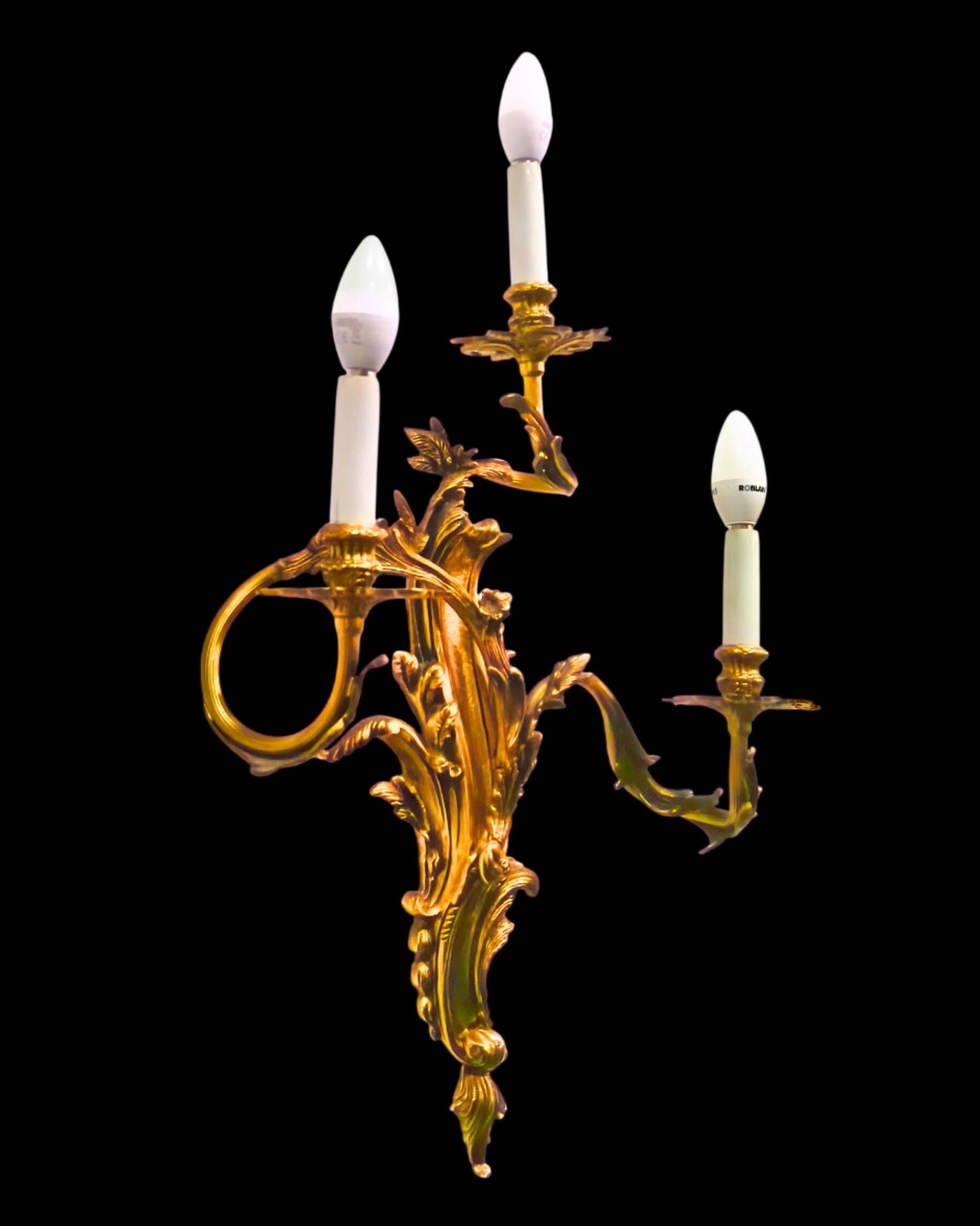 Pair of gilded bronze wall sconces in Rococo style, three lights.