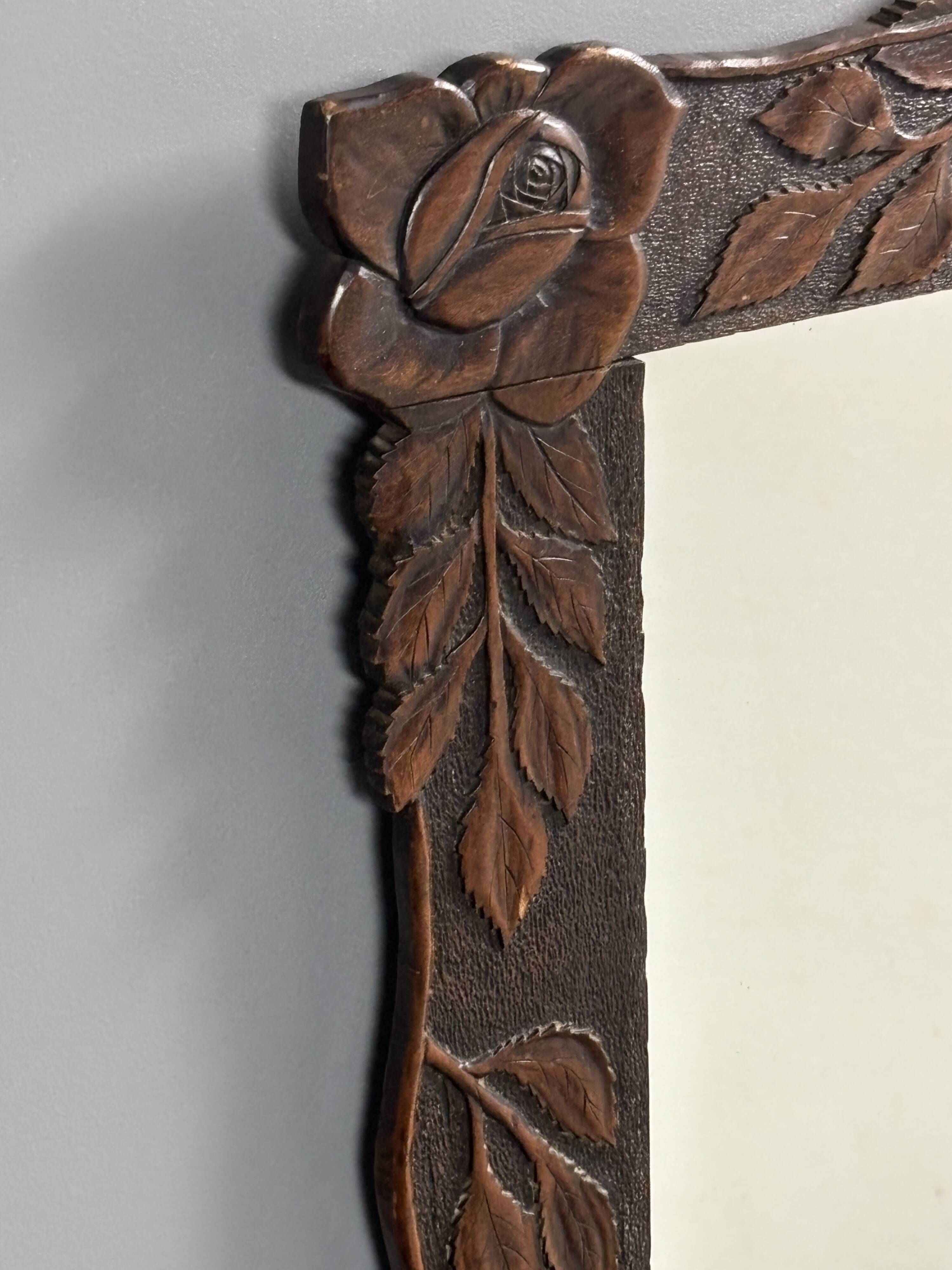 Arts & Crafts hand-carved wall mirror with floral roses, early 20th century