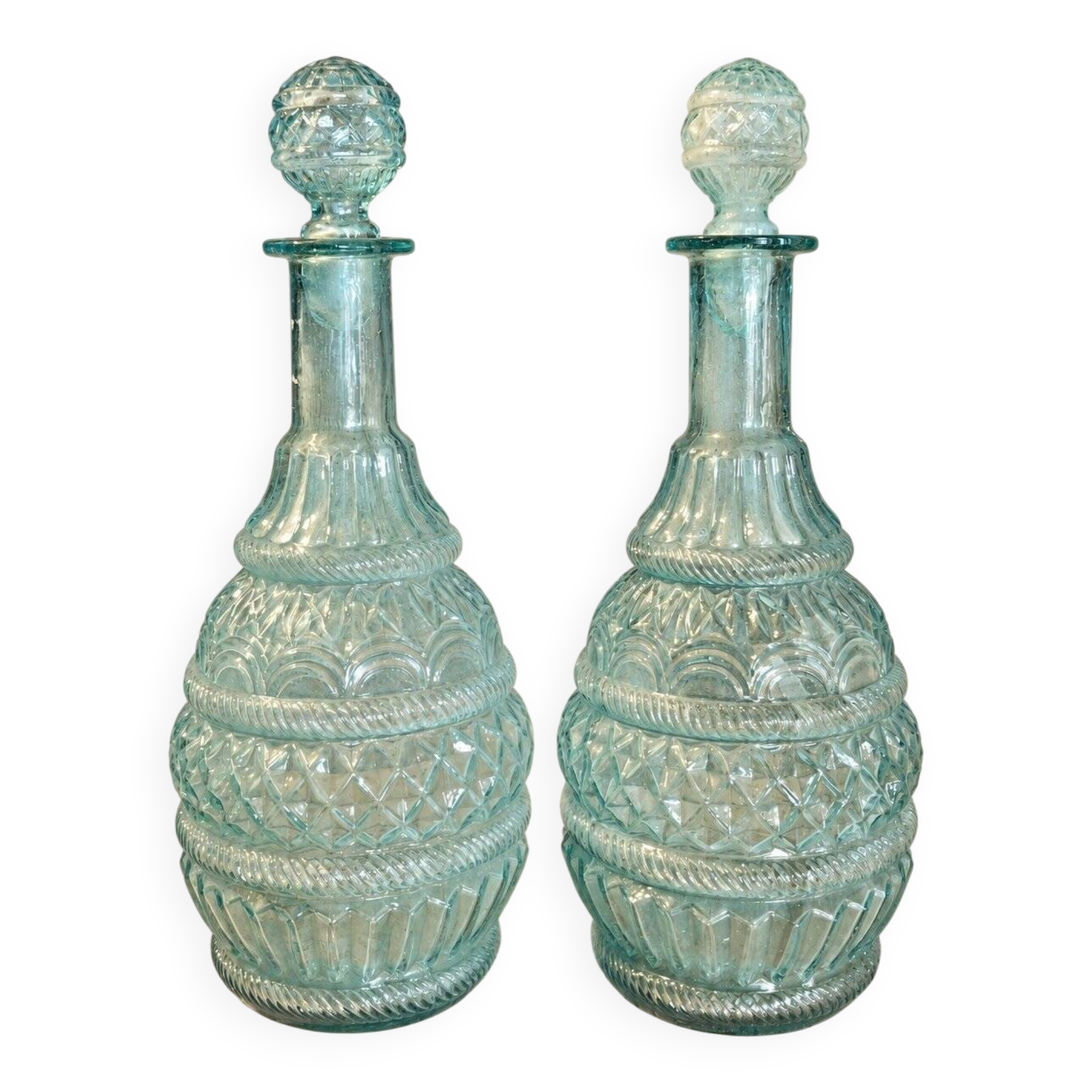 Pair of cut blown glass carafes in blue-green from the 19th century.