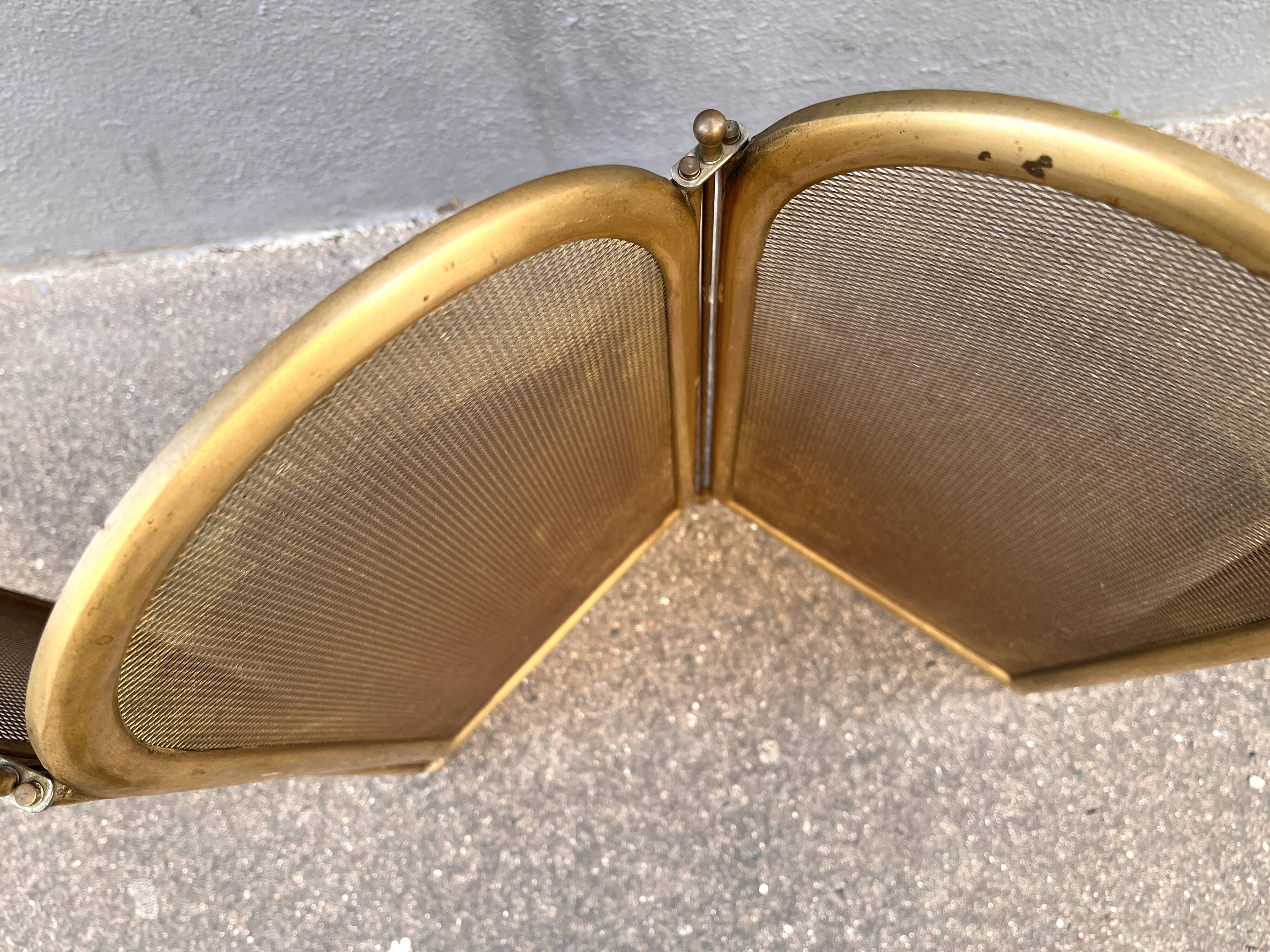 Antique brass fireplace screen from 1920, vintage spark guard.