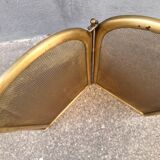 Antique brass fireplace screen from 1920, vintage spark guard.
