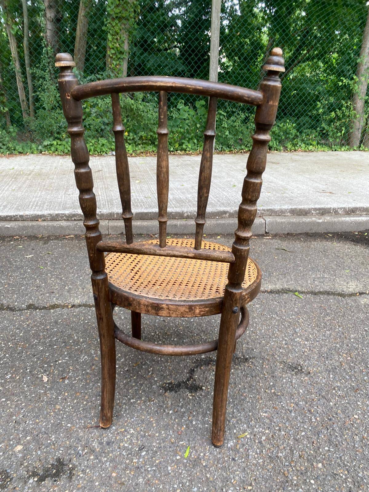 Vintage 19th-century bistro chair made of curved solid wood and caned in the Thonet style.