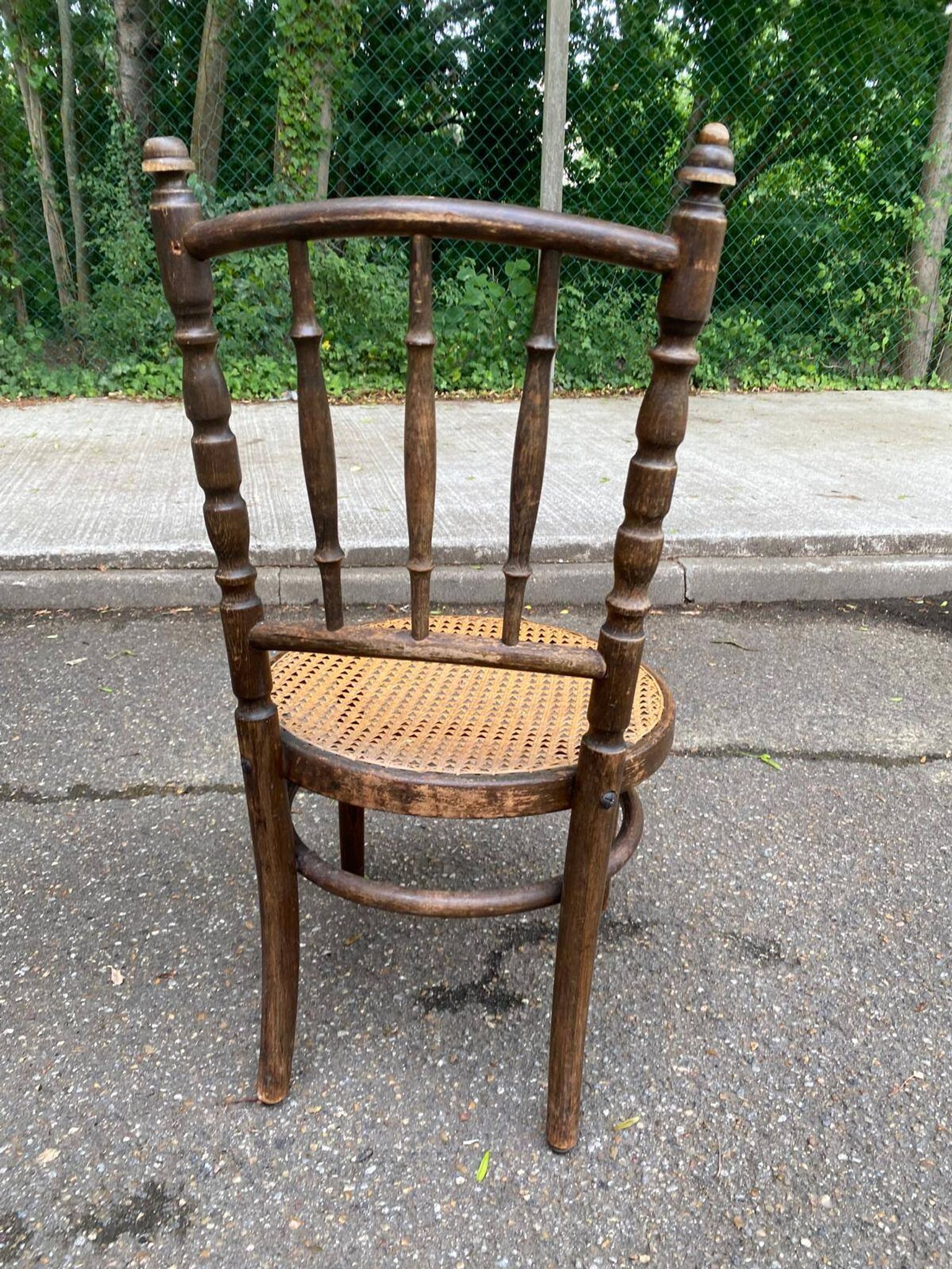 Vintage 19th-century bistro chair made of curved solid wood and caned in the Thonet style.