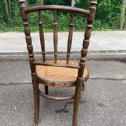 Vintage 19th-century bistro chair made of curved solid wood and caned in the Thonet style.