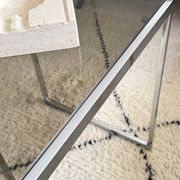 Set of 2 vintage nesting coffee tables in chrome metal and smoked glass.