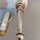 Neoclassical Torch two-arm wall lamp in solid brass, circa 1940