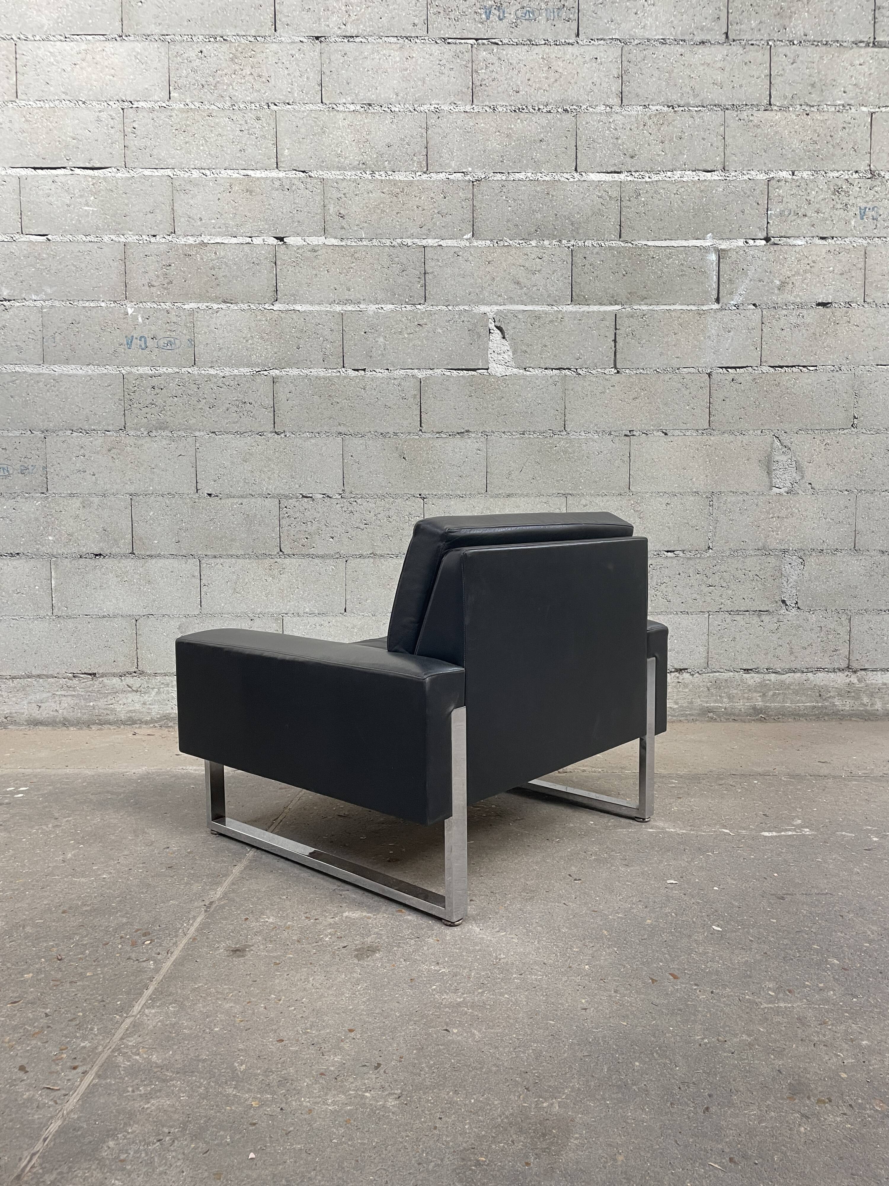 Pair of black leather armchairs