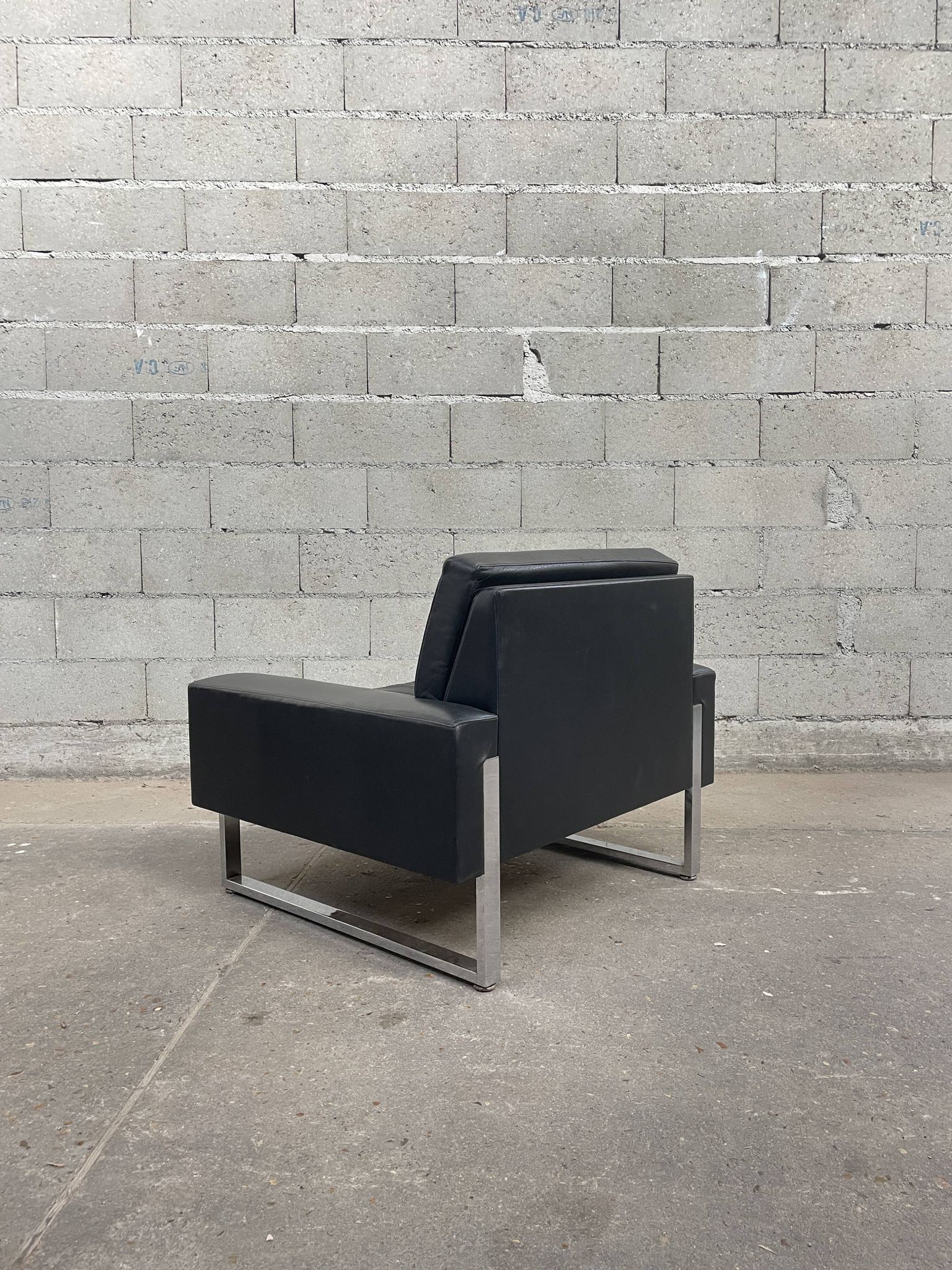 Pair of black leather armchairs