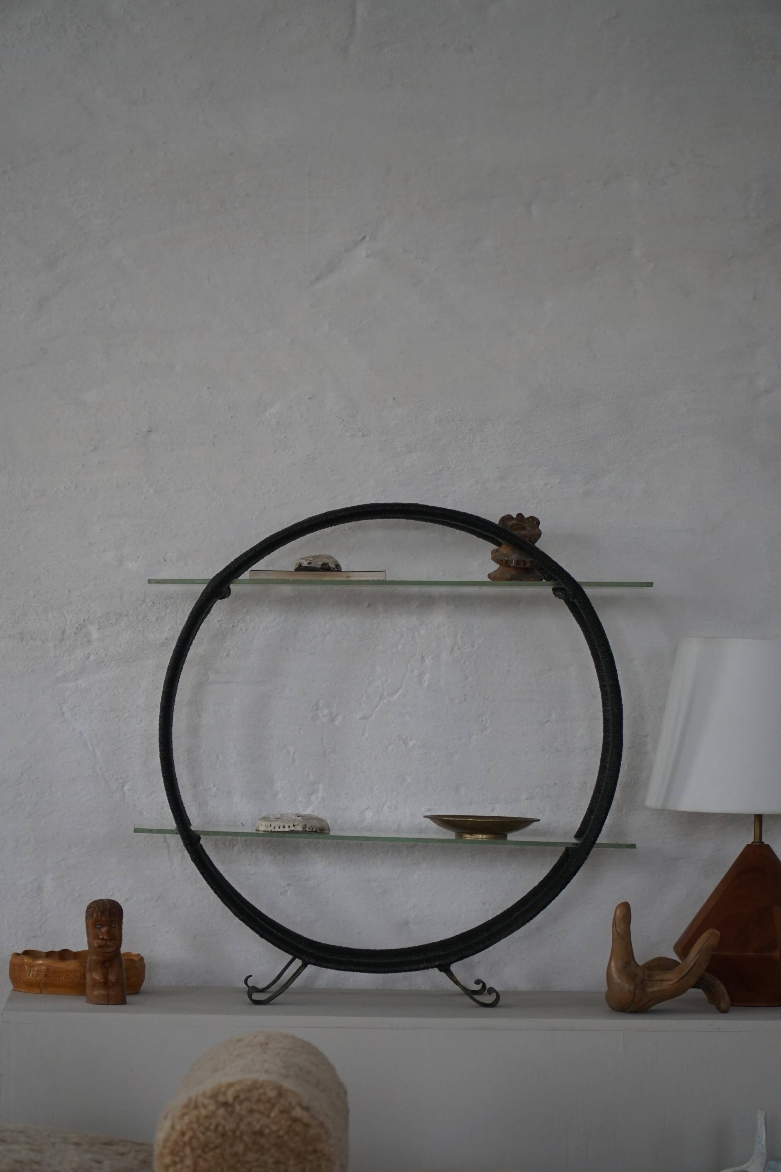 Decorative shelf unit, round metal frames with curved legs and glass shelves, 1960.