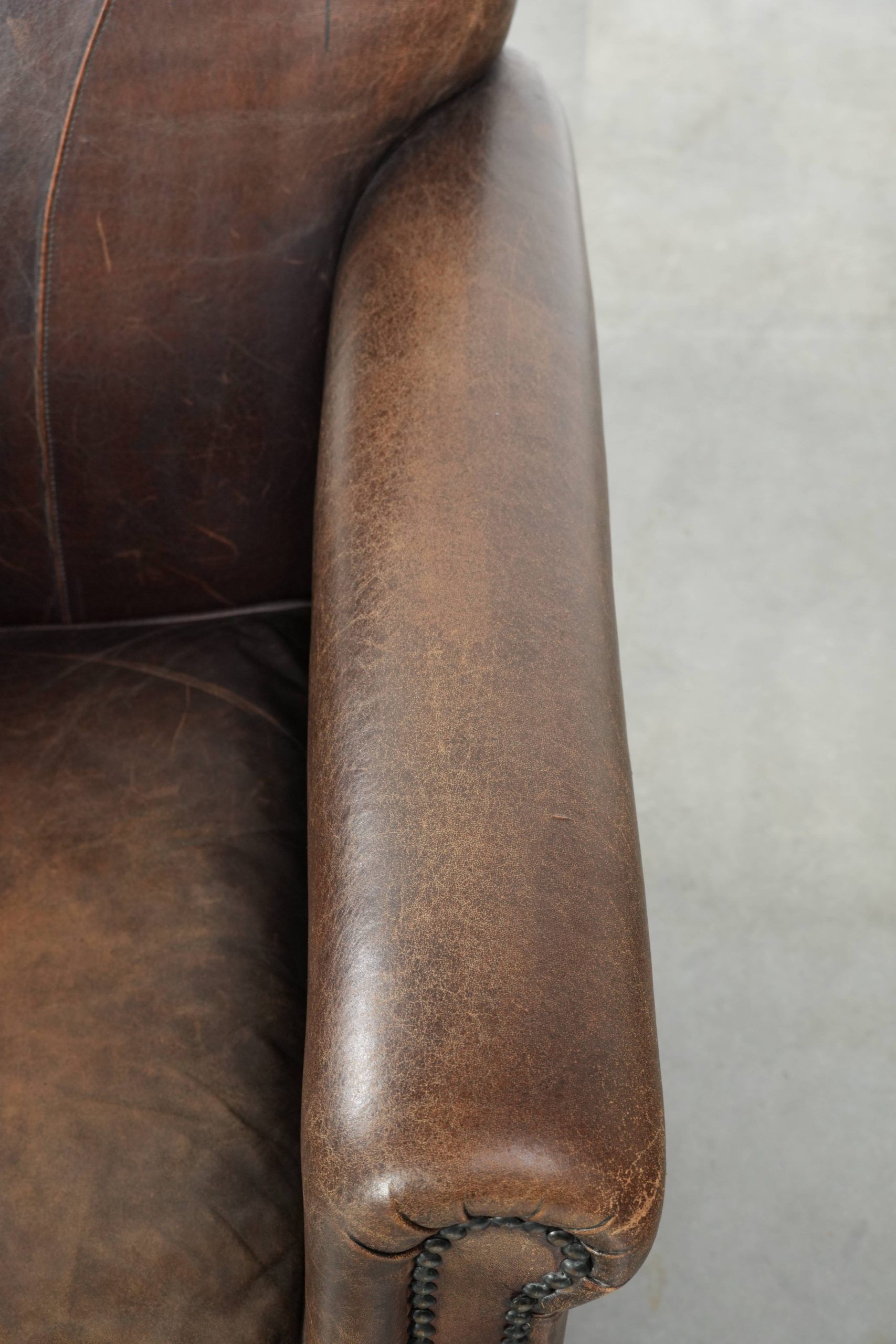 Characterful set of two sheepskin design armchairs with beautiful patina