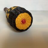 Old bottle in yellow, red and black scoubidou