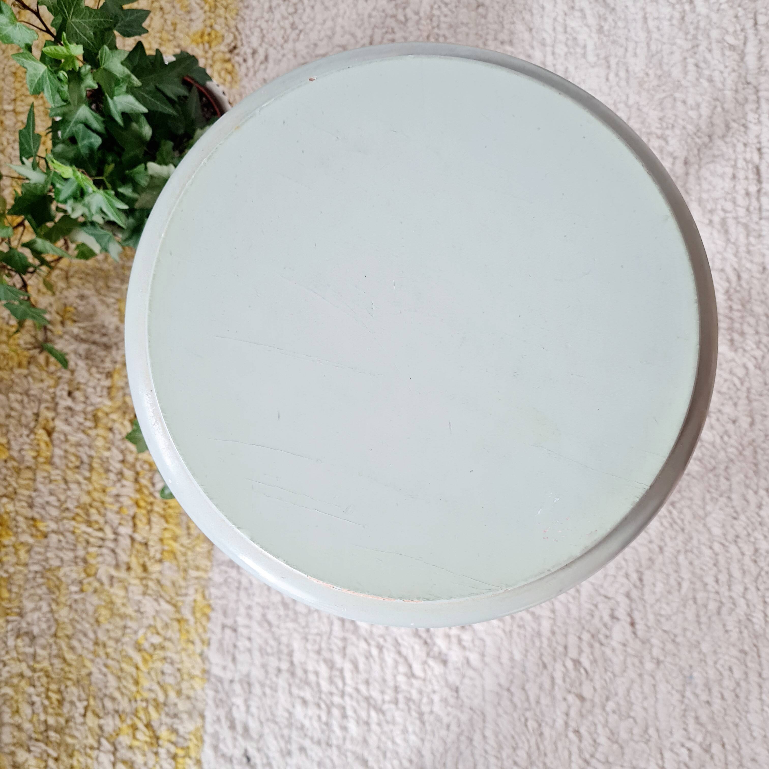 Antique tripod stool made of solid wood in blue.