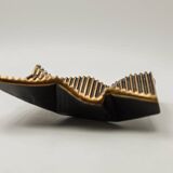 Brutalist bronze pocket emptier