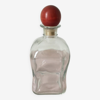Square carafe with its red wooden cap