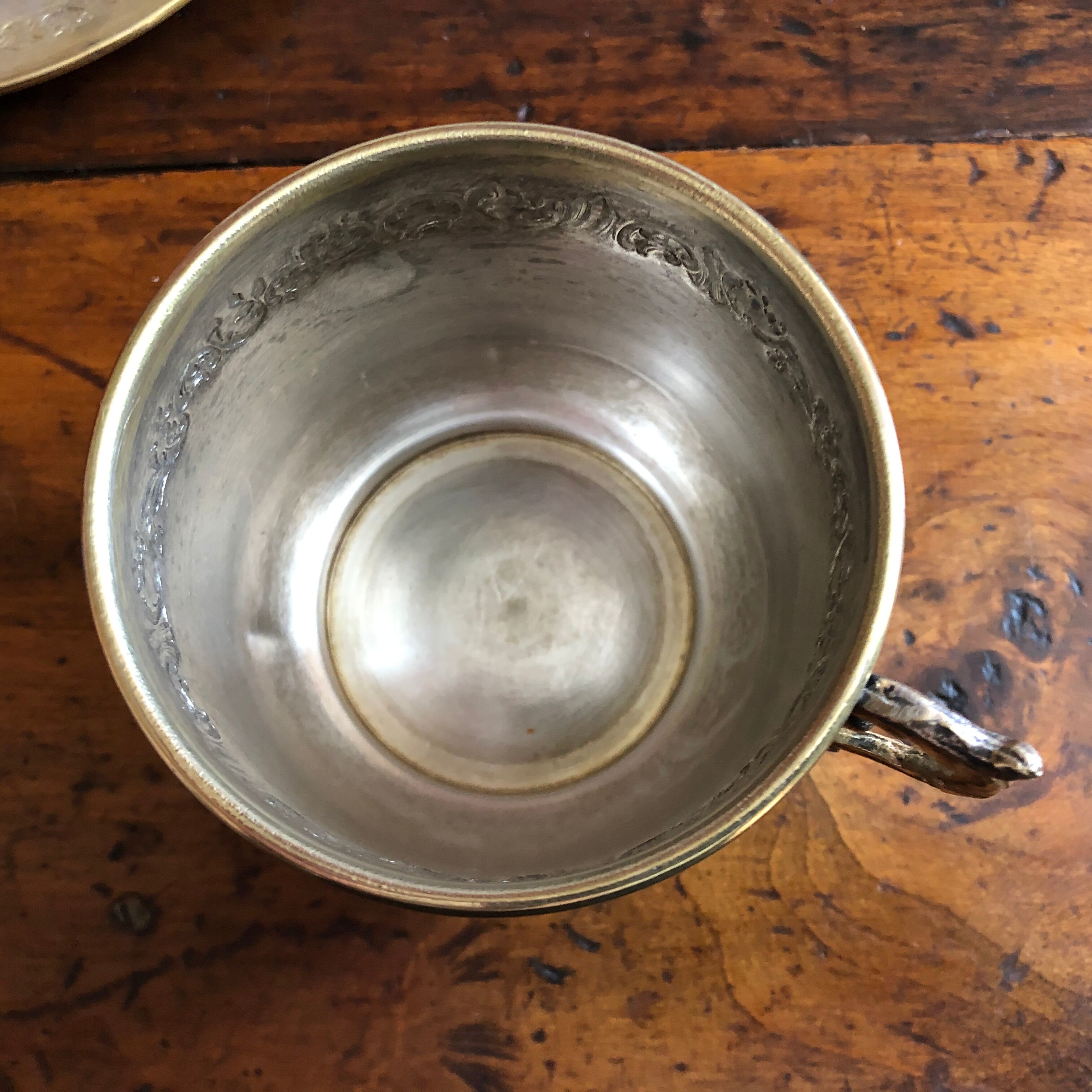 Silver metal cup and saucer