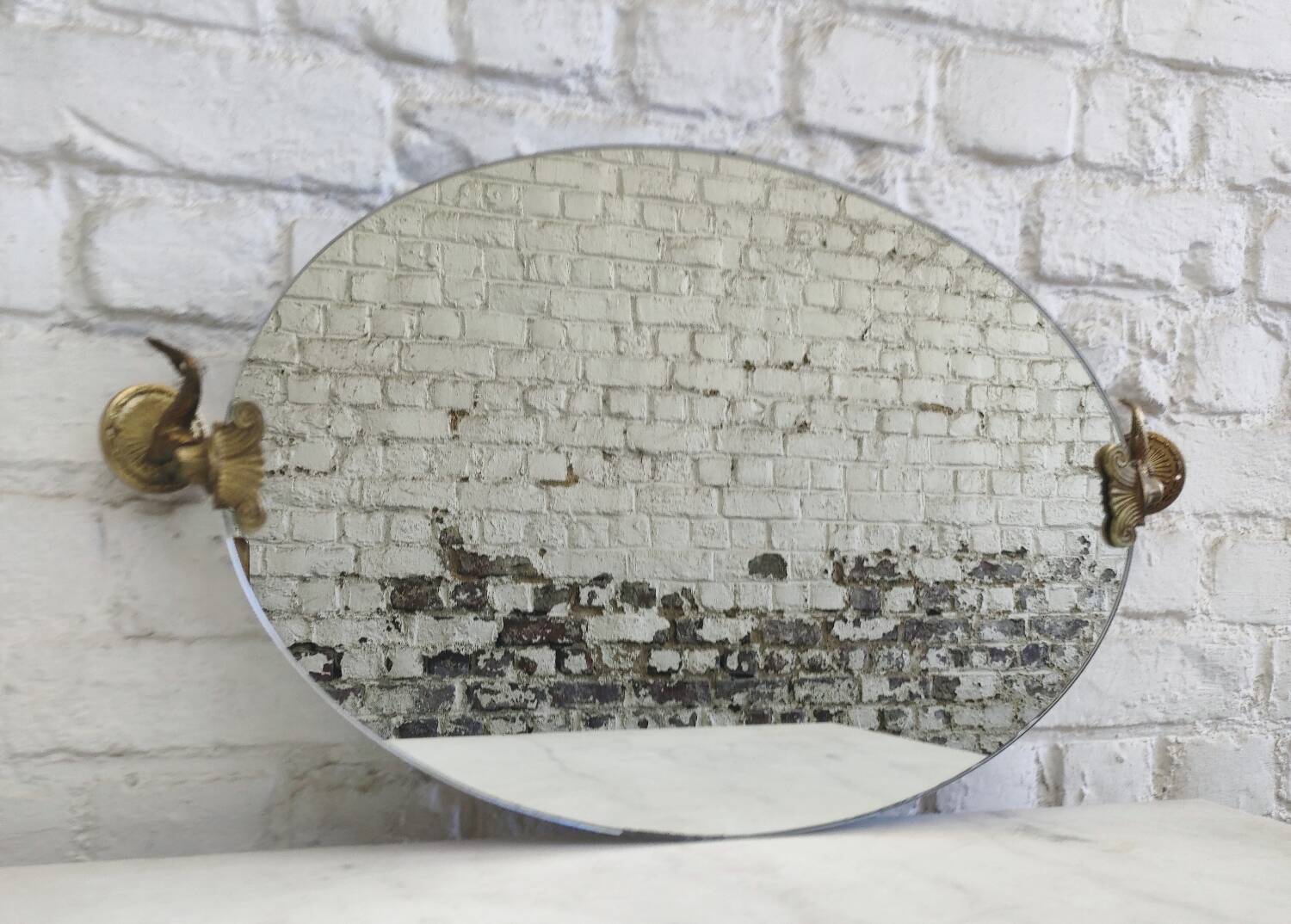 Vintage oval pivoting mirror in gilded brass with dolphins / Barber
