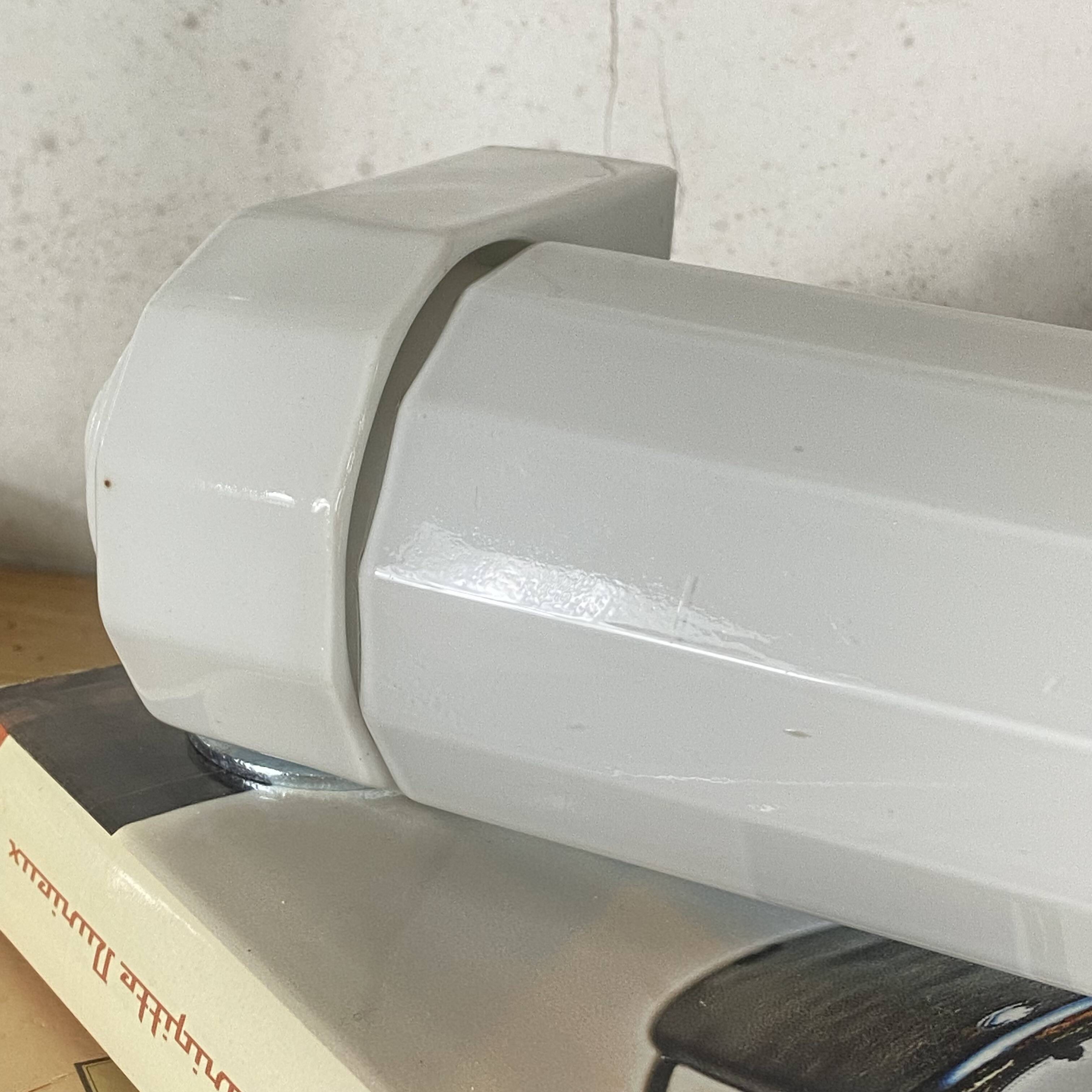 Art Deco tubular wall light in ceramic and white opaline glass tube.
