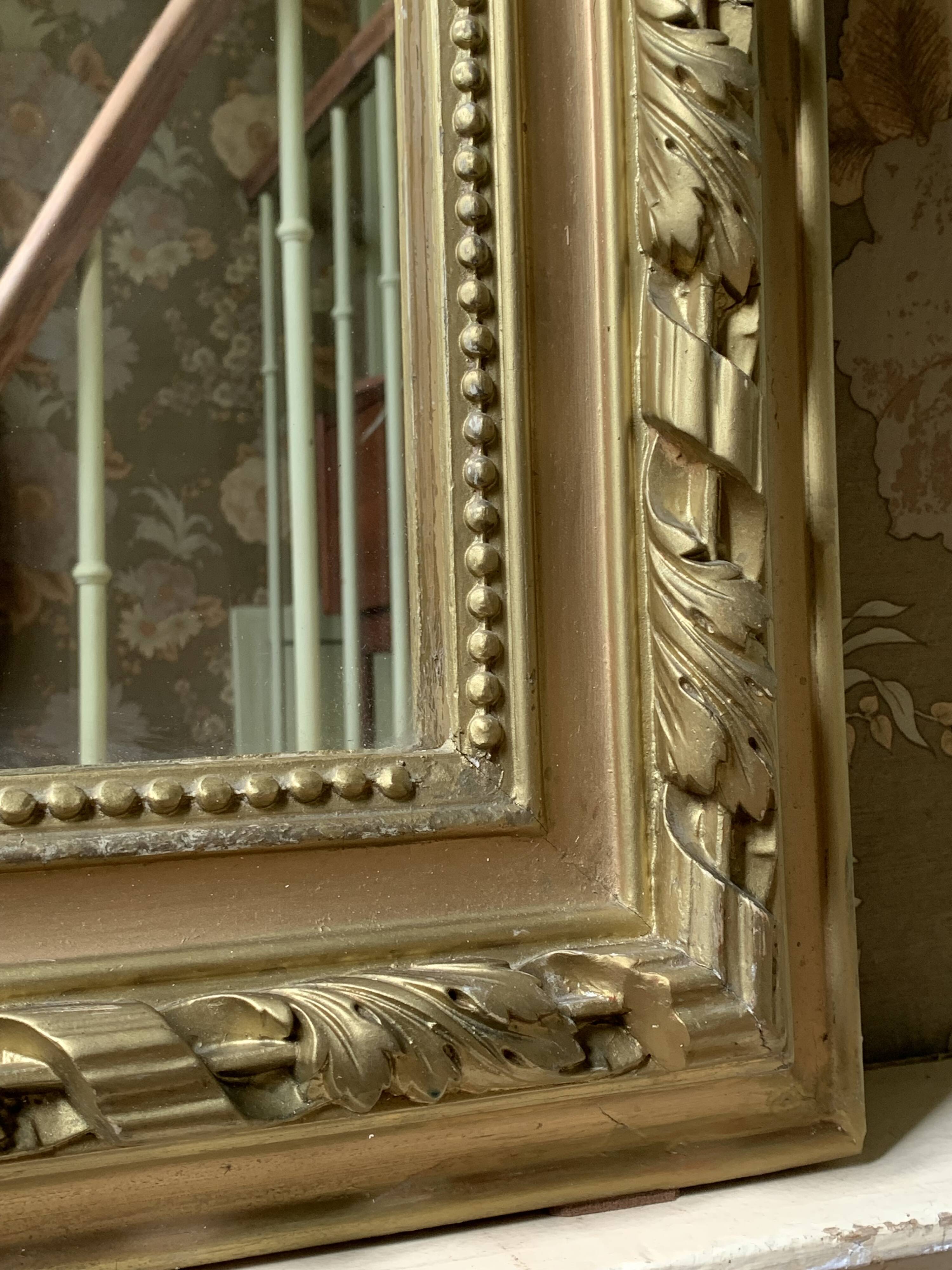 Gilded wooden fireplace mirror with pediment