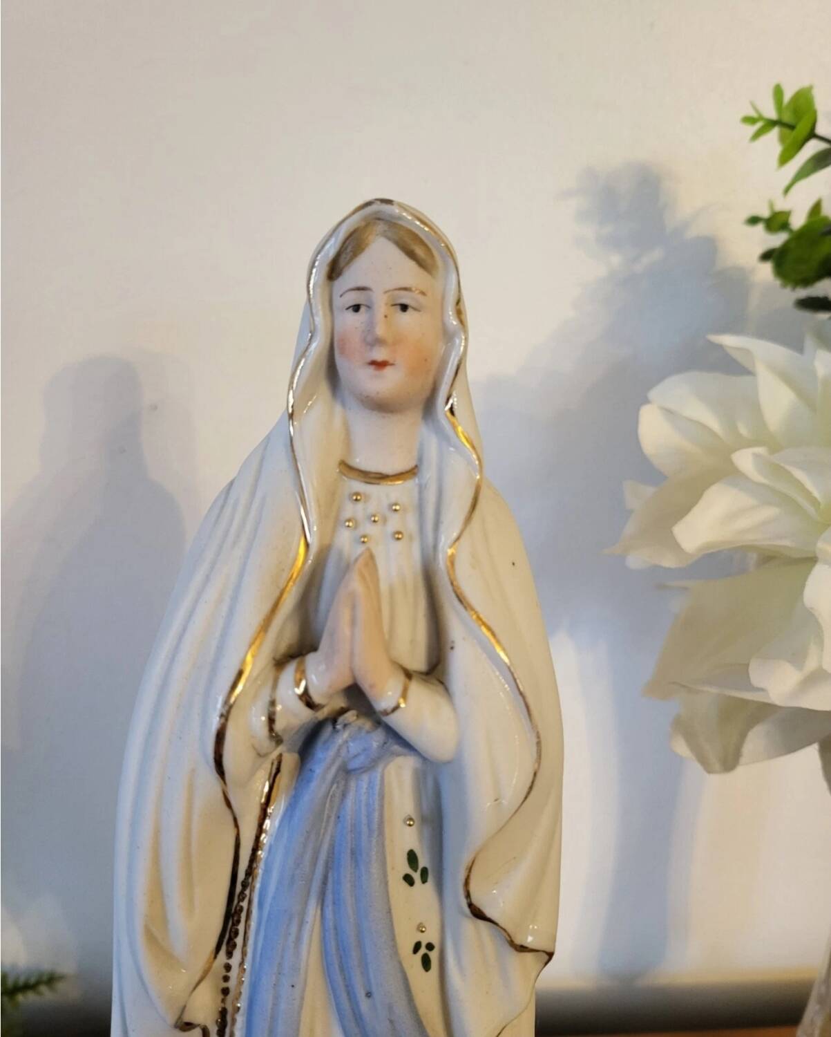 Religious statuette of the Virgin Mary in bisque porcelain