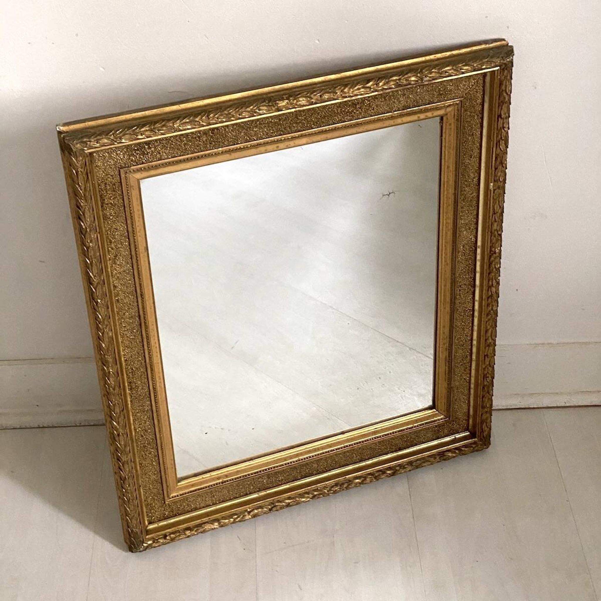 Small wooden mirror with gilded stucco in the Louis XVI style.