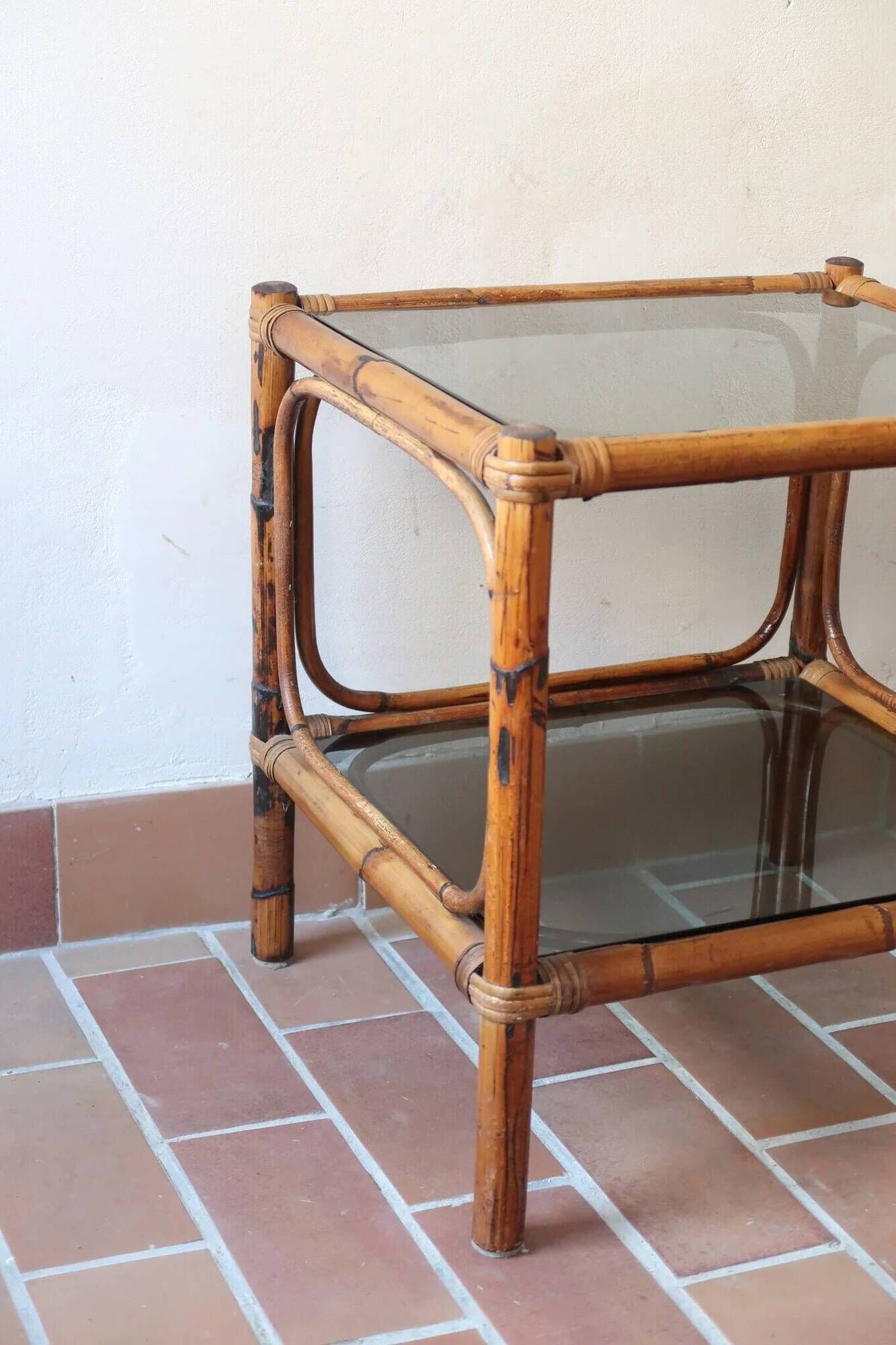 Pair of bamboo and rattan bedside tables, smoked glass tops.