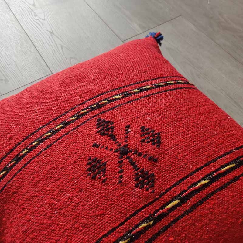 Red Berber cushion with cotton pompom