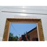 Wooden mirror and gold trim