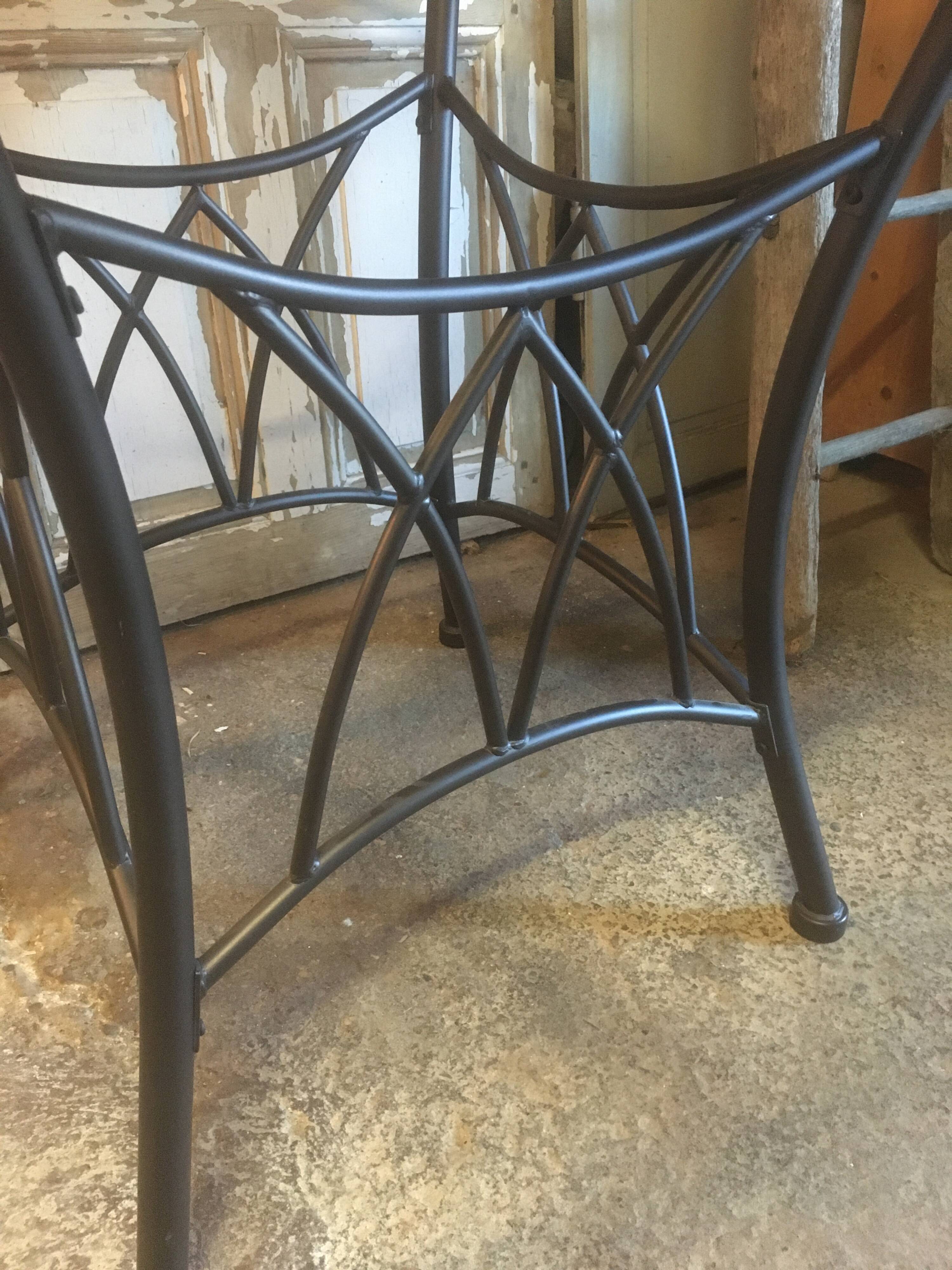 Round table with metal legs and smoked glass