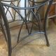 Round table with metal legs and smoked glass.