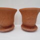 Duo of decorated terracotta wall flowerpots