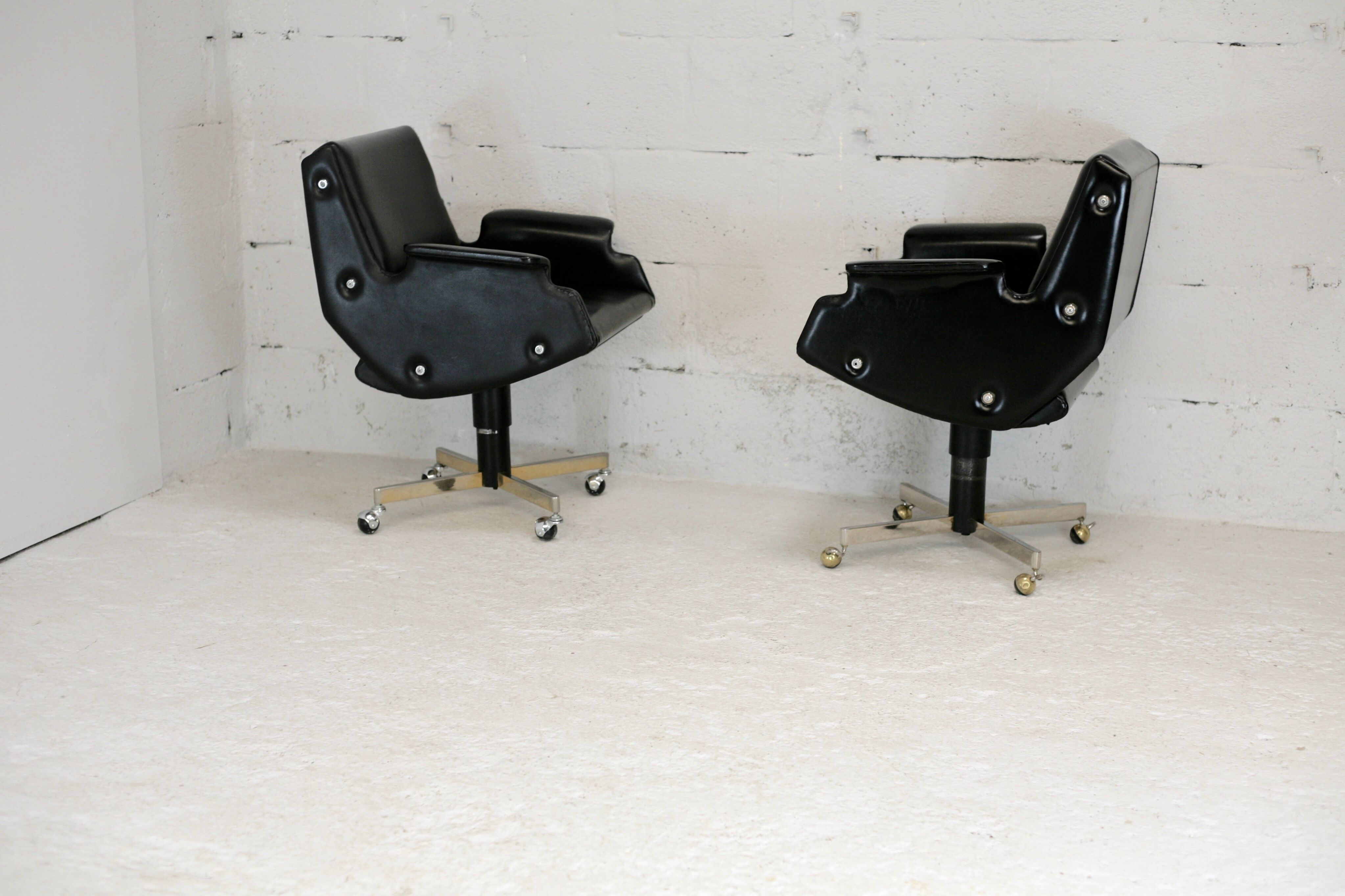 Pair of swivel armchairs, imitation leather and steel, Italy, circa 1960.