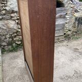 Oak two-column filing cabinet with curtains.