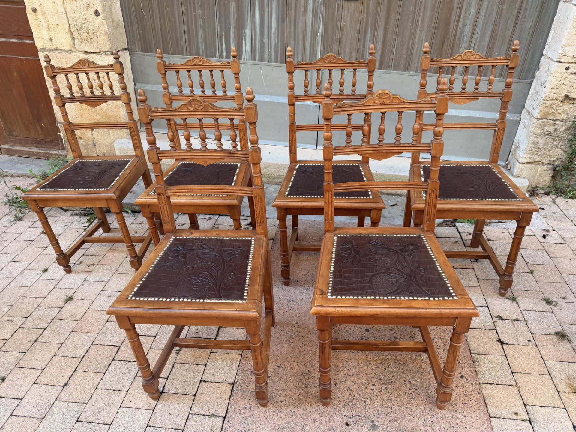 Set of 6 antique turned wooden chairs with embossed leather seats.