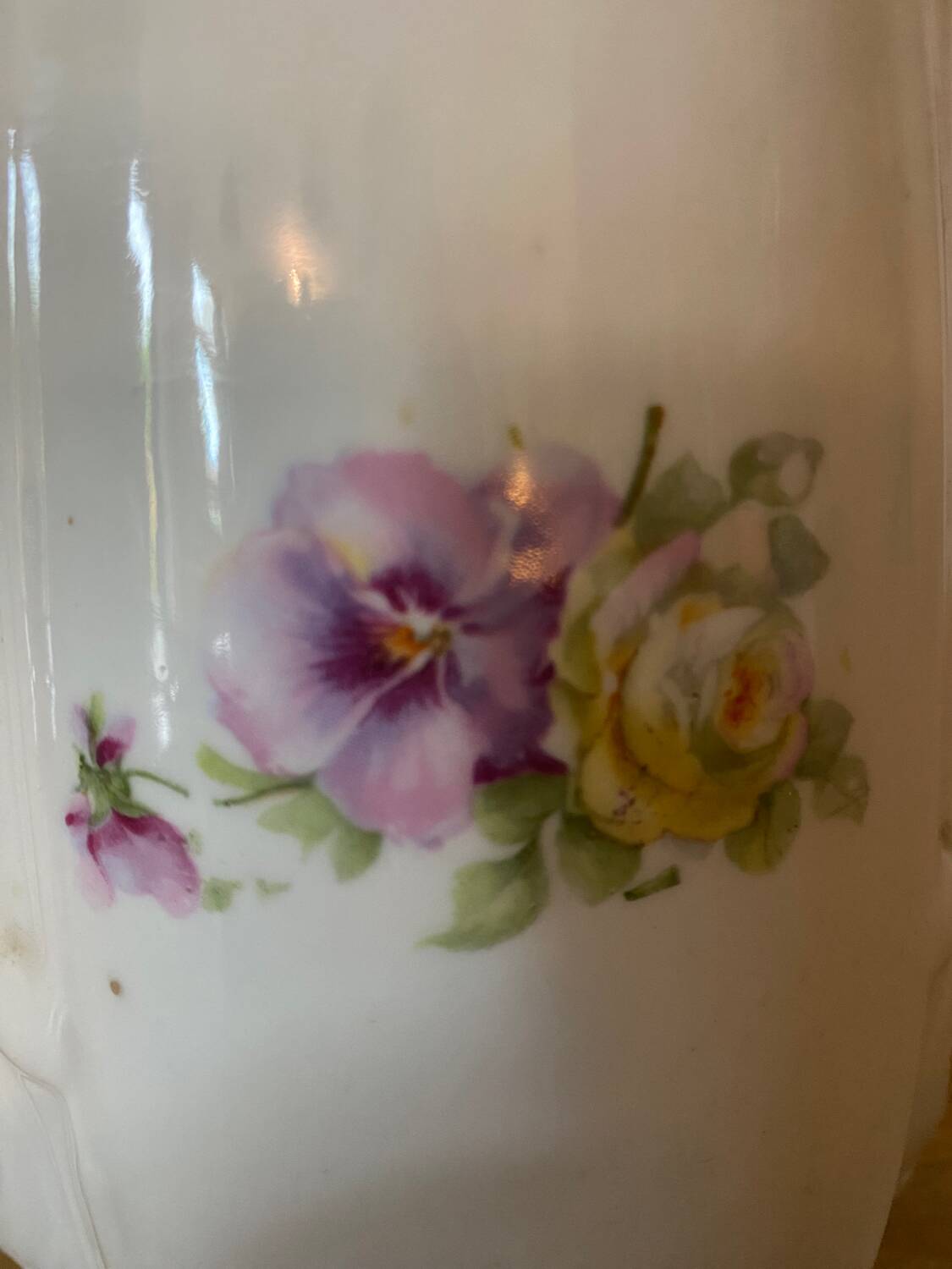 Old ceramic pitcher decorated with flowers