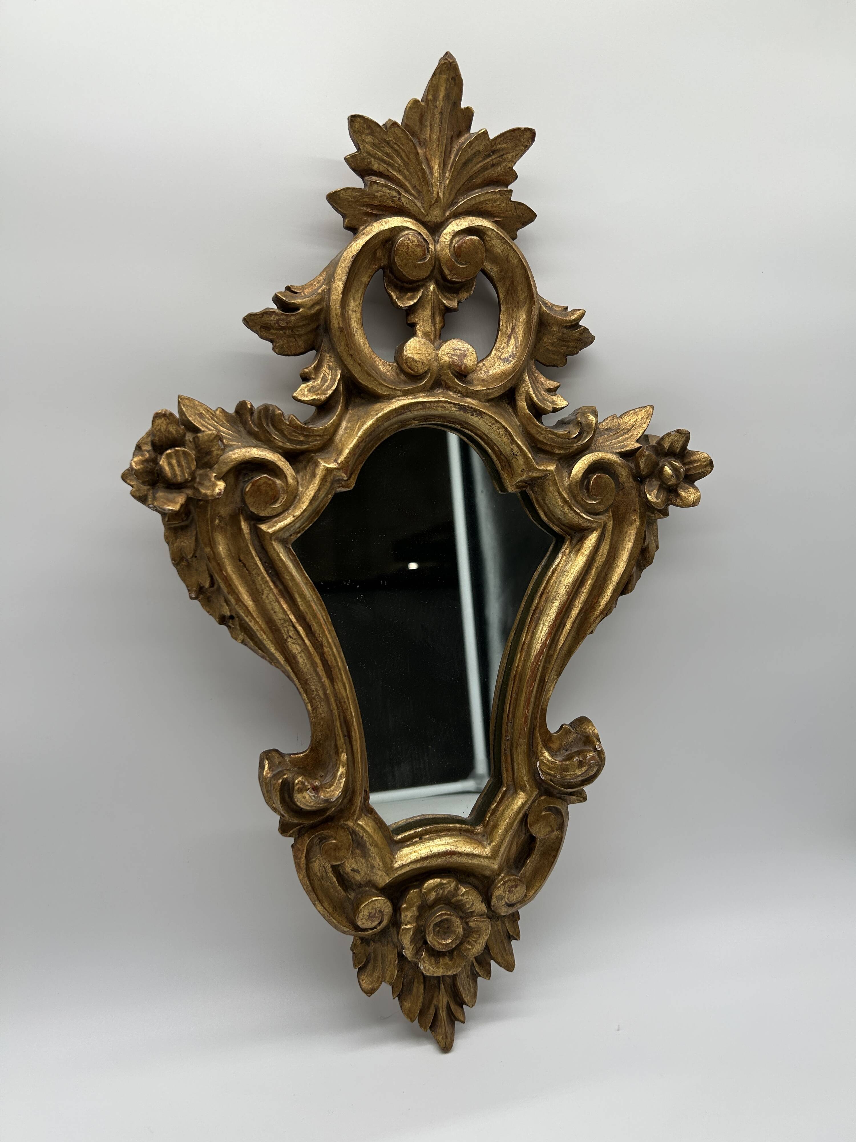 Wooden mirror with gilded stucco