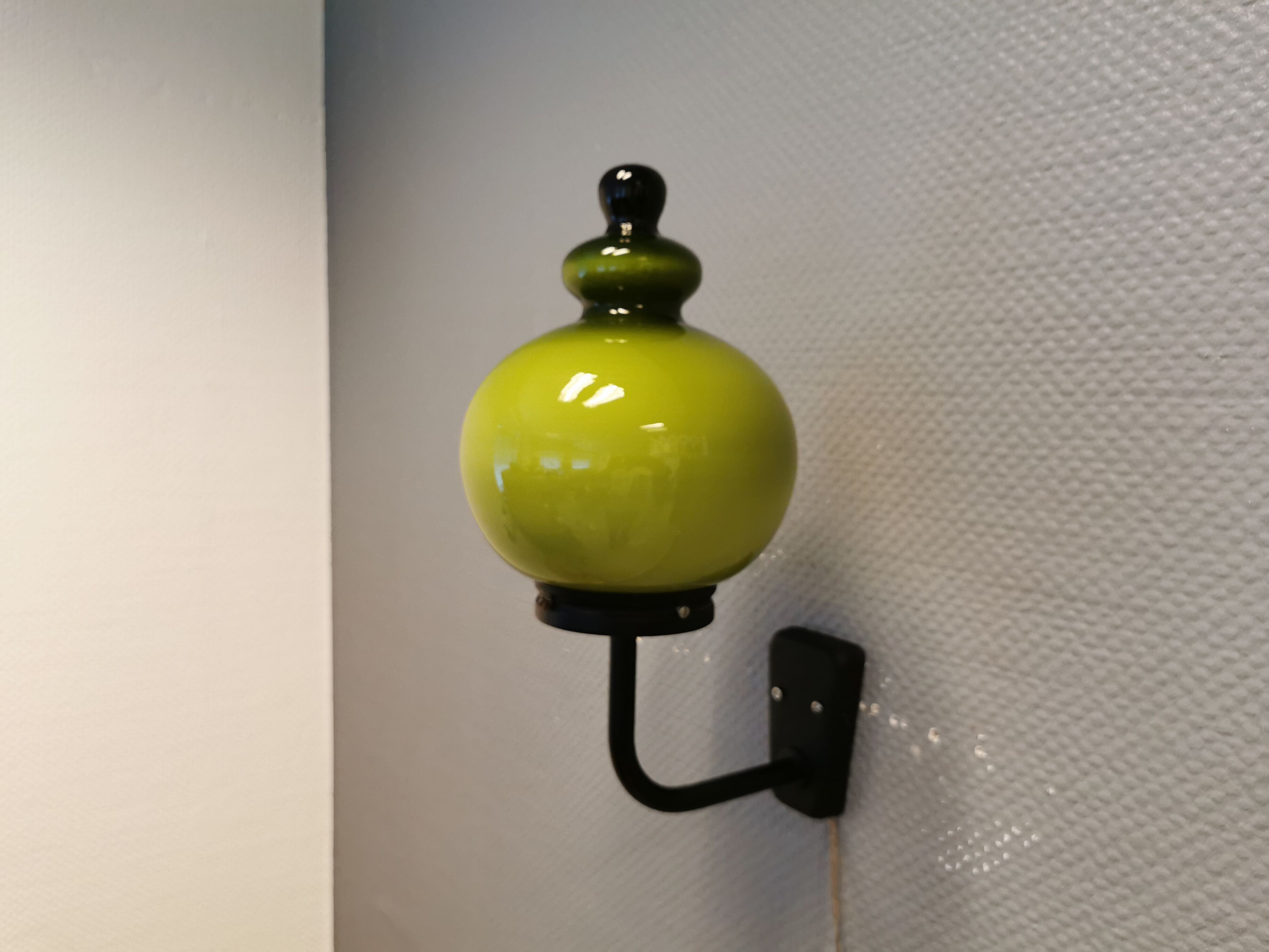 Wall light, made in black metal frame with olive green glass shade