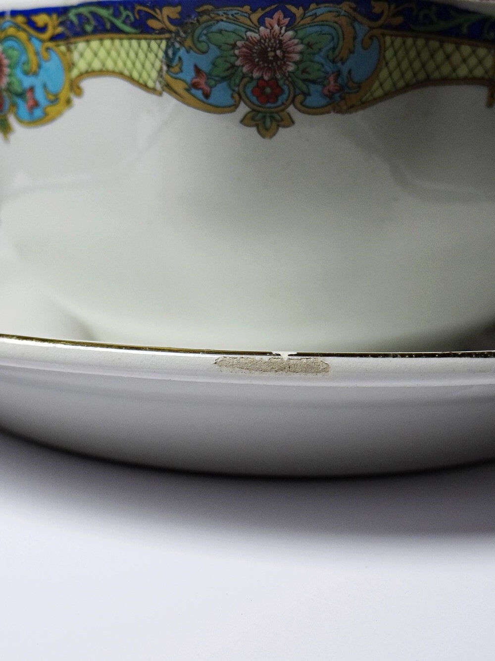 Old Lunéville sauce boat, opaque porcelain with polychrome decoration.