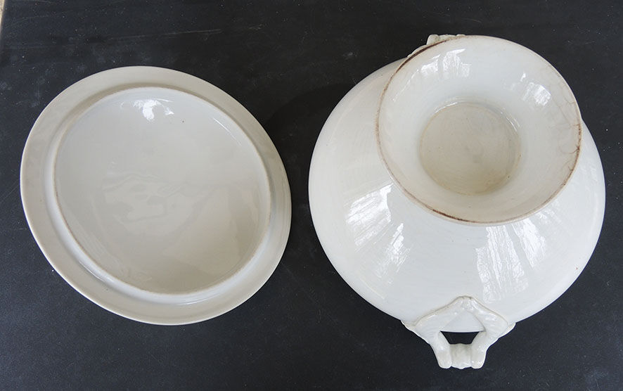 Old white ceramic soup bowl pine cone